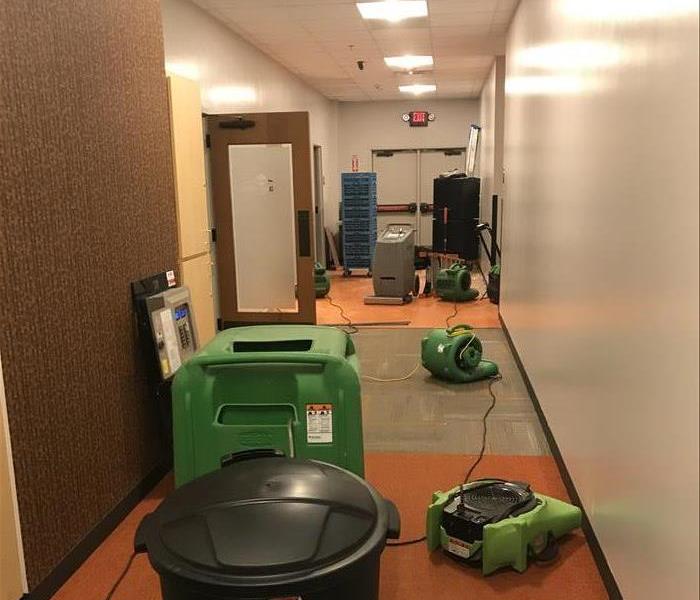 Water drying equipment in commercial hallway.